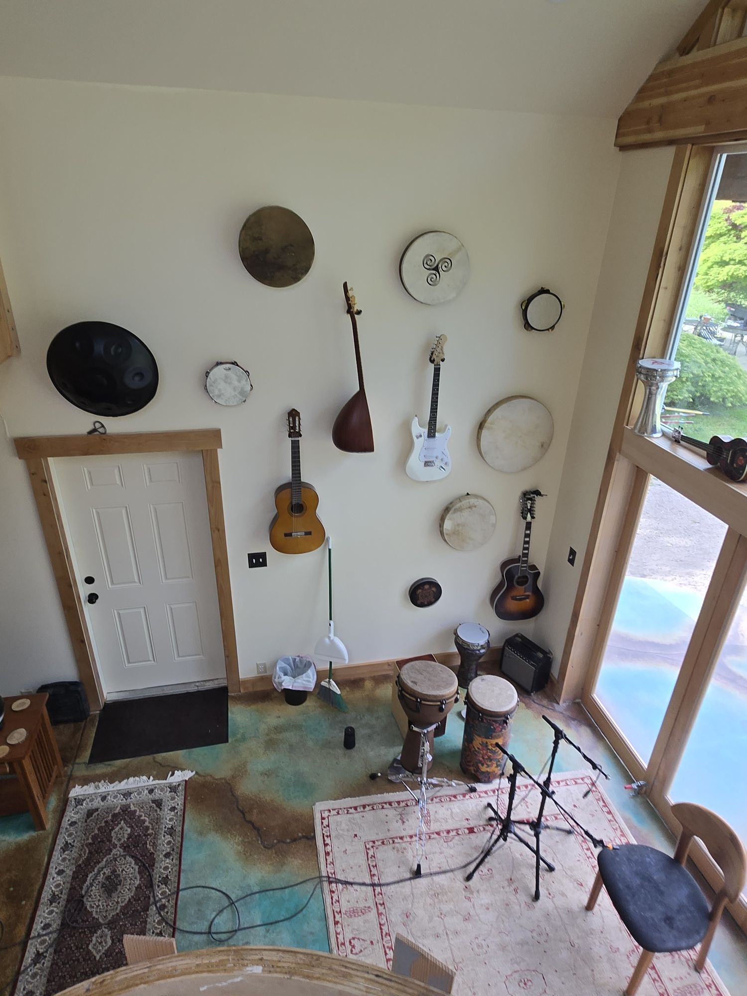 Instrument wall at Alpenglow Studio with guitars, hand drums and percussion